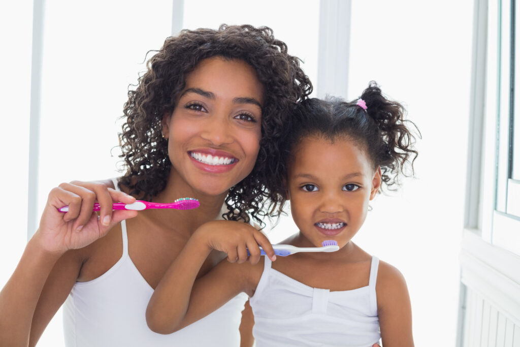 image of woman and child brushing