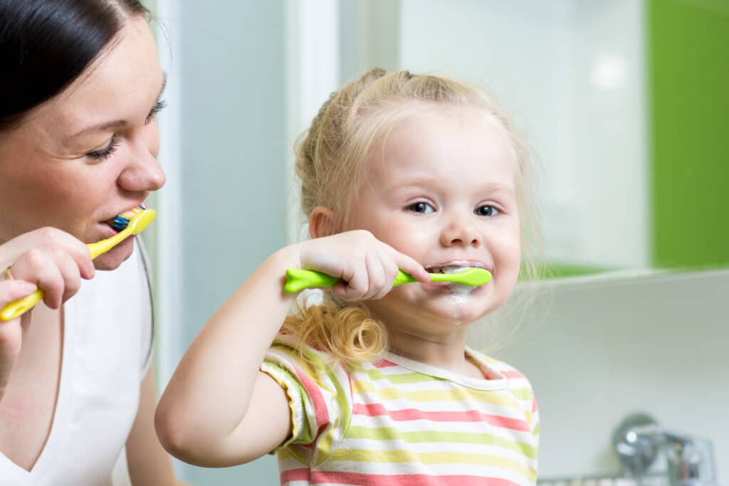 image of woman and child brushing